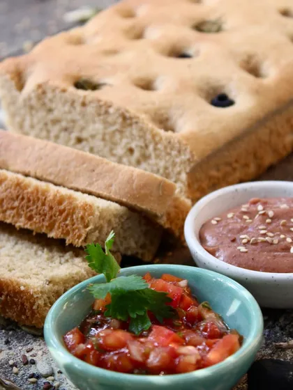 We bake our own breads in-house, like this whole-wheat focaccia with olives and rosemary. It's the perfect base for our sandwiches or to be enjoyed with our delicious dips.