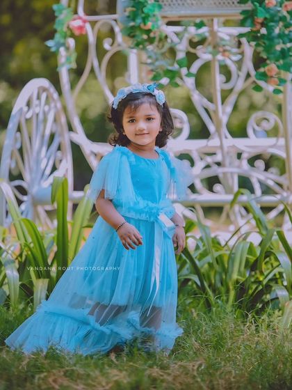 Another shot of our little Cinderella, this time with a beautiful white carriage prop in the background. The entire setup is designed to create a fairytale atmosphere.