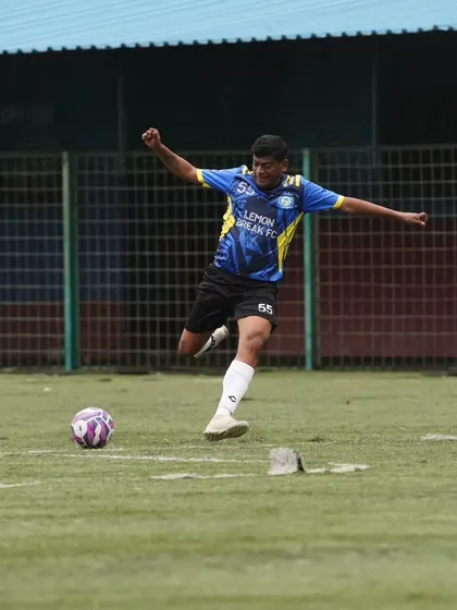 A player unleashes a powerful shot during a competitive league match. We play with full intensity, proving that passion for football has no age limit.