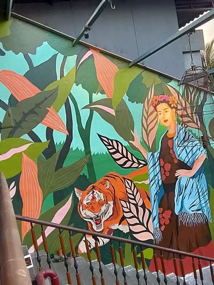 A full shot of our Frida Kahlo mural at 1522 Mumbai. The composition balances the iconic artist with a powerful tiger and lush foliage, creating a narrative of strength and nature that we designed specifically for the space.