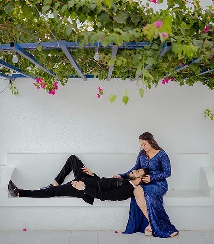 A relaxed and romantic moment under a canopy of bougainvillea. Priyanshi sits as Yash lays his head in her lap, a perfect picture of love in a beautiful, serene setting.