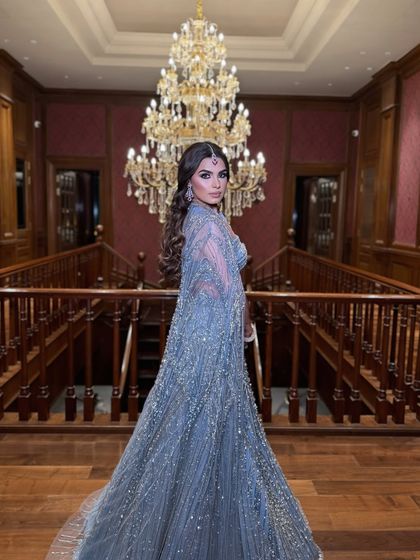 A wide shot of Kanu at her cocktail event. The makeup ensures she stands out as the bride, even from a distance.