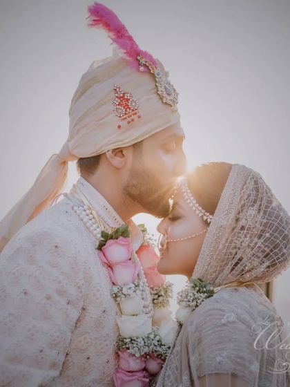 A stunning silhouette shot of the groom kissing his bride's forehead against the setting sun. This is the kind of magical, golden-hour moment I aim to create at every wedding.
