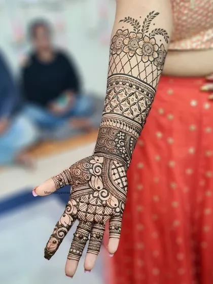 A lovely full-arm design that combines floral netting with bold, traditional Indian patterns.