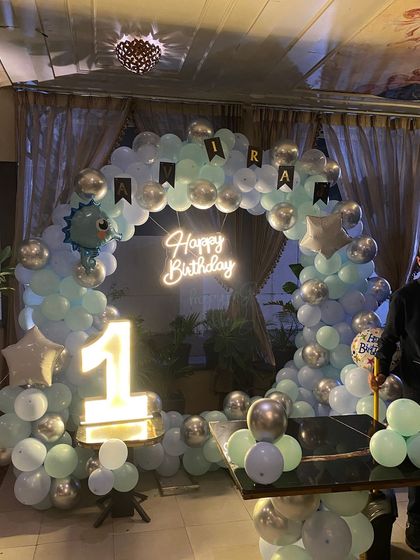 A complete view of the dinosaur-themed first birthday party setup.