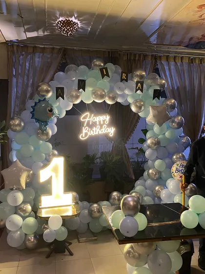 A complete view of the dinosaur-themed first birthday party setup.