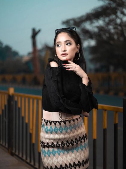 A close-up of the model from the winter shoot, showing the clean makeup, defined brows, and simple hairstyle that complete this chic look.