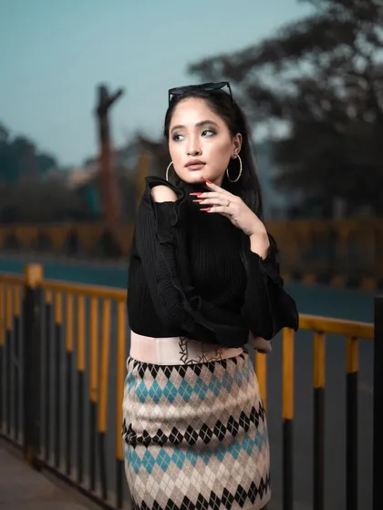 A close-up of the model from the winter shoot, showing the clean makeup, defined brows, and simple hairstyle that complete this chic look.