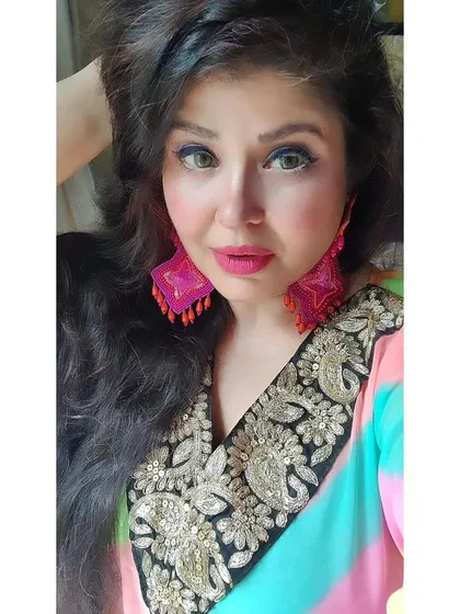 Feminism to me is about being the best I can be. Here I am in my rainbow kaftan with a hand-embroidered neckline, paired with matching hand-embroidered earrings. This piece is all about celebrating life in full color.