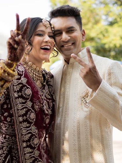 A fun, candid portrait of the couple making peace signs at the camera. We love capturing your true, playful personalities.