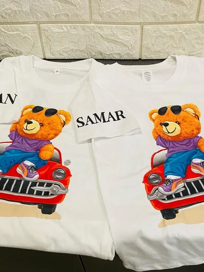 Twin in style with these adorable personalised t-shirts. Featuring a cool teddy bear in a car, these shirts are customised with names on the sleeves.