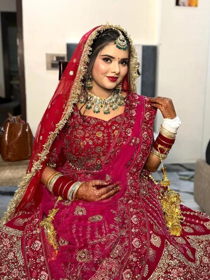 My bride Nikita looking absolutely stunning in her red lehenga. Her smile shows how happy and confident she felt with her soft glam makeup.