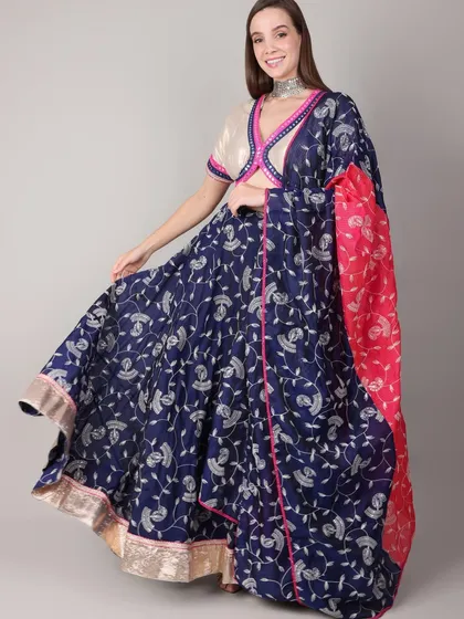 For Navratri, we created this royal blue lehenga set, perfect for a vibrant dandiya night. The flowing skirt allows for beautiful movement, while the off-white blouse with pink and blue mirror work trim adds a playful contrast. It’s a complete look that balances traditional charm with festive energy.