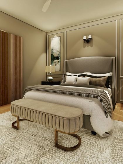 A classic and elegant bedroom design featuring wall molding, a wingback headboard, and a neutral color scheme. The wooden partition adds a touch of modern warmth, while the plush rug and bench provide comfort.
