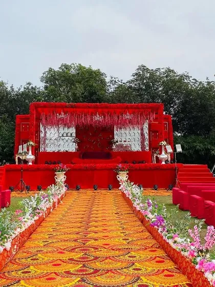 A wide shot of the all-red stage, showing the guest seating and the impressive scale of the setup.