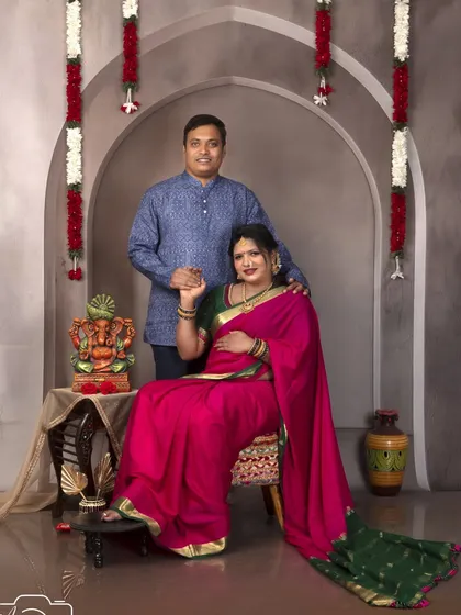 A classic family portrait in our vintage arch setup. The couple looks regal in their traditional attire.