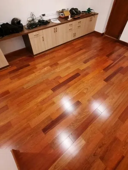 Look at the deep, rich tones of this polished hardwood floor. This is a real project in progress, showing how I bring warmth and luxury into a space. This type of solid wood flooring is an investment in timeless style and durability.