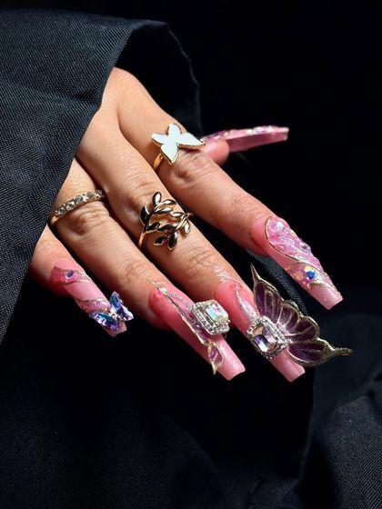 The intricate details of the butterfly wings and the placement of tiny crystals are highlighted in this shot.