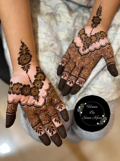 This is a lovely example of a simple party mehendi design. It features a floral 'bel' or vine on one hand, with a complementary motif on the other for a balanced look.