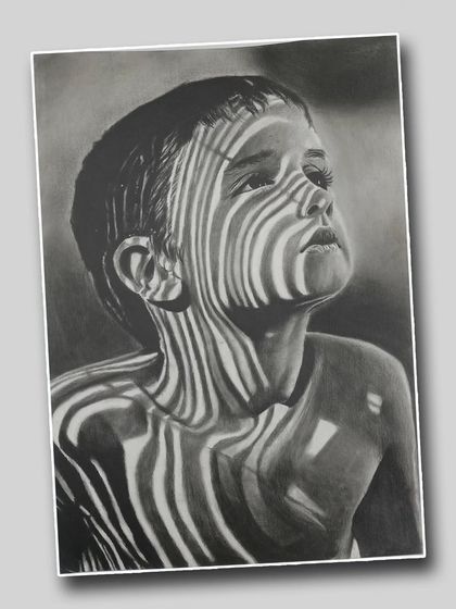 A striking pencil portrait using light and shadow projected onto a child's face. This advanced technique creates a unique and captivating visual effect.