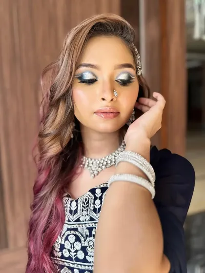 An eyes-closed shot to fully display the intricate full cut-crease technique, blending silver, grey, and black for a dramatic and defined eye look.