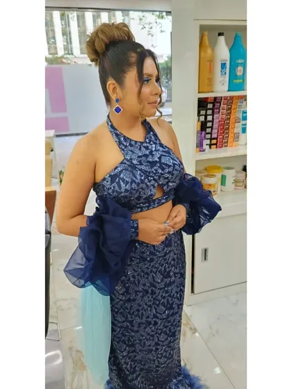 A side profile of a client after her party makeover session. The intricate updo and expertly applied makeup are visible, showcasing the detailed work of our talented stylists.