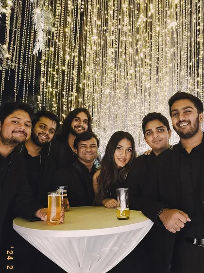 A quick post-gig huddle. After the lights go down, we're still just a group of friends who love making music together. This is us grabbing a drink after a fantastic wedding gig.