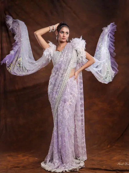 Another angle of the lavender saree, showing the model adjusting her hair. This adds a touch of candid elegance to the designer lookbook.
