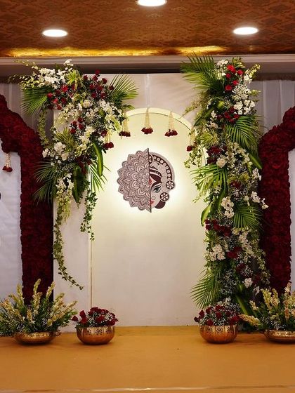 Another angle of the 'Mitakshi' stage, highlighting the symmetry of the design with floral-topped arches and peacock panels flanking the central deity artwork.