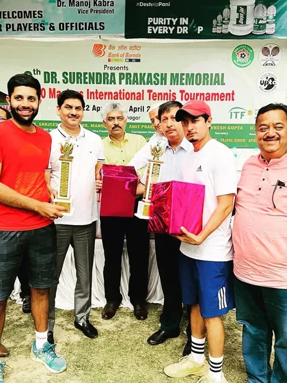 Receiving our trophies at the ITF 400 Masters International Ranking Tournament. Every win is a team win.