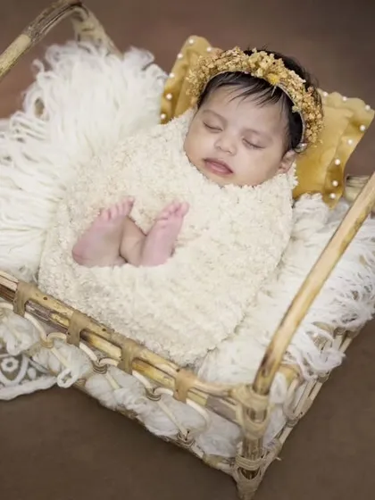 This sleeping beauty is styled in a cozy bohemian theme. The soft textures and neutral tones create a timeless and serene portrait of this precious newborn.