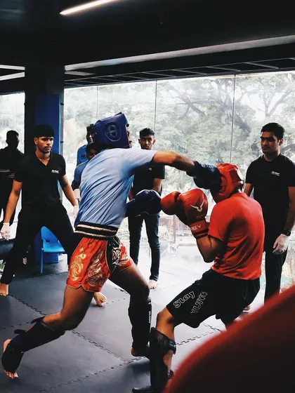 A fighter lands a clean punch during a competitive sparring match at our club wars event.