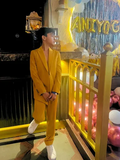I also create bespoke pieces for younger clients. This vibrant mustard suit was custom-tailored for a young star, bringing a bold and playful twist to celebration style.