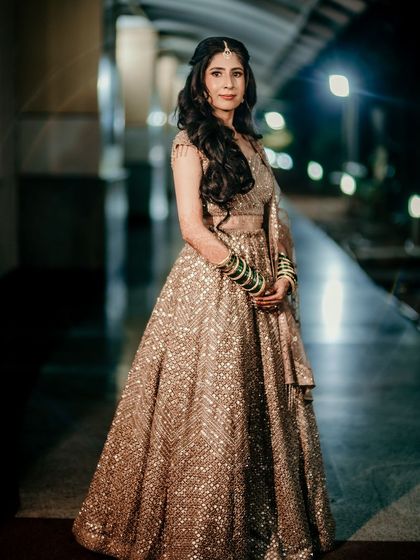 A full-length shot of her reception look, the lehenga sparkling under the lights.