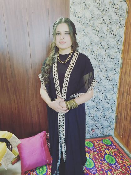 A half-up style with two small braids on either side, leading into soft waves. This is a lovely, bohemian-inspired look.