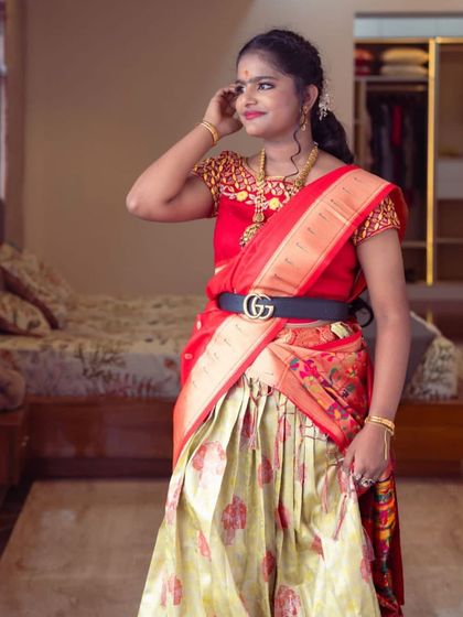 A vibrant and youthful look for a traditional half-saree function. The makeup is kept fresh and glowing to match the bright colors of her outfit.