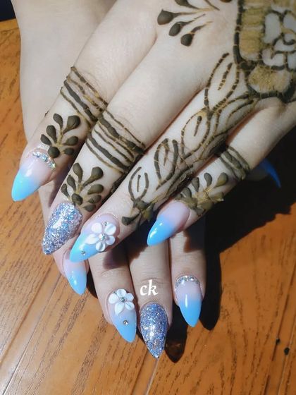 A dreamy blue ombre set perfect for a sangeet or reception. I added silver glitter accent nails and 3D white flowers with rhinestone centers for extra sparkle.