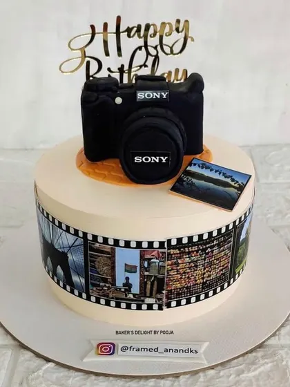 A different angle of the photography-themed cake, highlighting the edible film strip and the detailed camera topper.