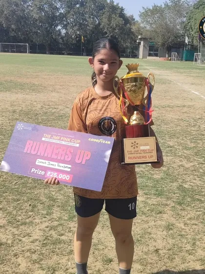 One of our players proudly displays the runners-up trophy and prize check from the JMF Pink Cup tournament.