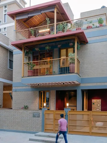 The front view of the house, showing the entrance and the warm, inviting color palette.
