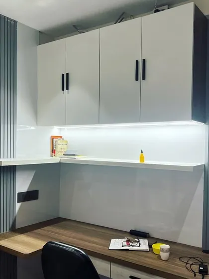 This view highlights the full scope of the custom-built study unit, demonstrating how it fits perfectly into the corner of the room to create a functional and stylish home office space.