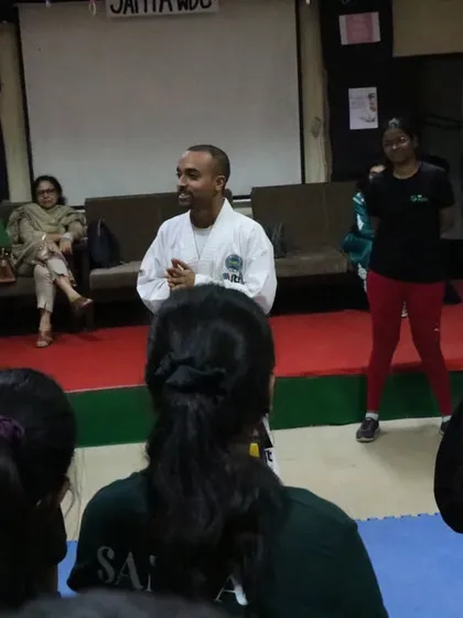 The atmosphere in my workshops is interactive and engaging. Here, I'm working with participants, ensuring everyone feels comfortable and involved in the learning process.
