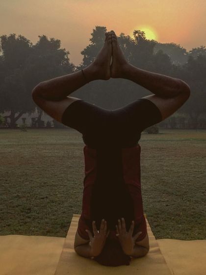 This bound angle variation in a headstand, practiced against the morning sun, is a beautiful expression of flexibility and balance. It shows how we can find grace and stability even when we are upside down.