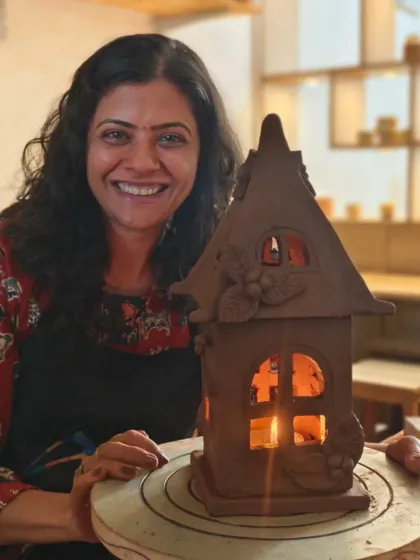 See how a simple piece of clay can be transformed into a beautiful, functional piece of art. This student proudly displays the charming clay house lantern she crafted, which now fills her home with a warm, handmade glow.