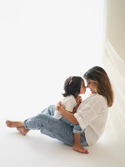 Sometimes, the most powerful photos are the simplest. This quiet, nose-to-nose moment between a mommy and her little one is from a minimalist studio session, where the focus is all on your connection.