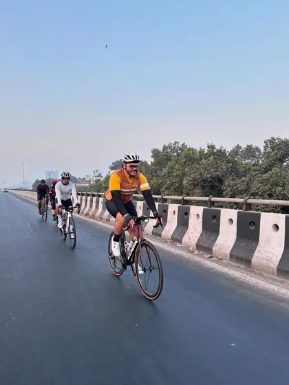 A rider enjoying the open road during our Sunday morning ride. These moments of freedom are what cycling is all about.