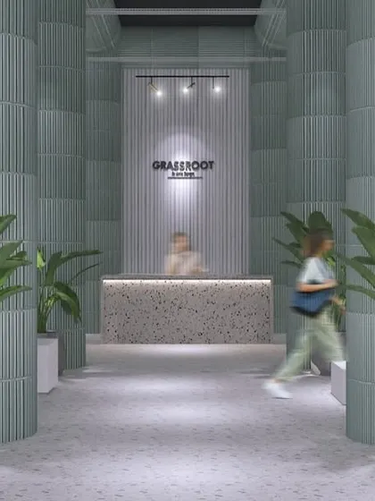 The welcoming entrance to the GRASSROOT retail store. The design uses fluted columns, terrazzo counters, and lush greenery to create a bright, natural, and calming atmosphere that invites customers to explore.