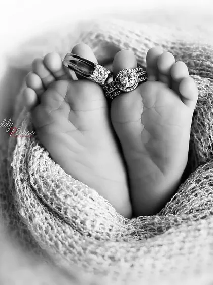 A timeless black and white version of the classic baby feet shot, with the parents' rings placed on the toes. The monochrome edit adds a classic, artistic feel to the portrait.