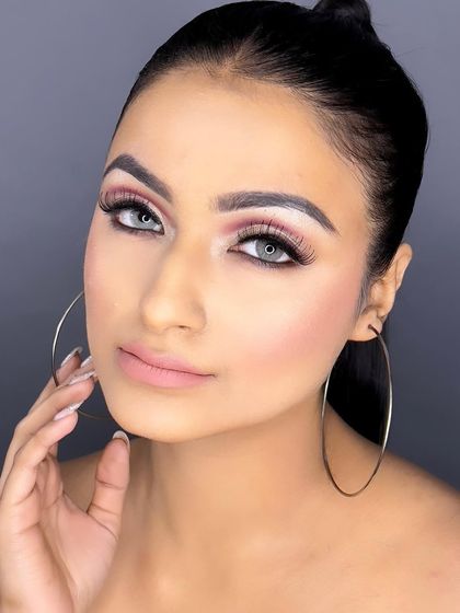 This look is bold and confident, featuring dramatic lashes and a perfectly sculpted brow.