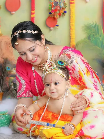 A happy baby Krishna with his loving mother. The smiles in these photos are always so genuine and heartwarming.